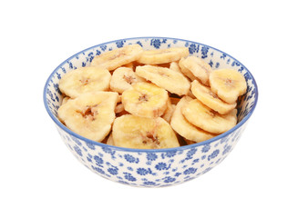 Dried banana chips in a blue and white china bowl