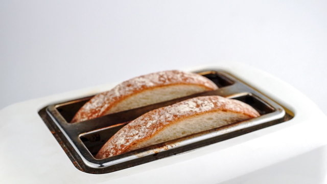 Slow motion time lapse of bread being toasted in toaster