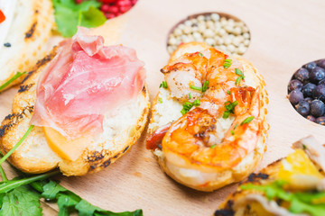 mix of traditional Spanish tapas on a wooden plate with decor
