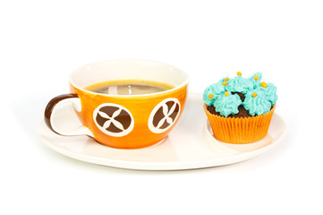 Cup of coffee and cupcake with blue cream frosting