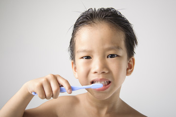 The boy brushing to clean his teeth.