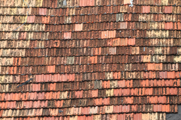 Detail of old roof tiles in uneven colors