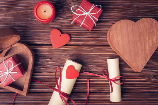 Valentines day background with gift boxes, candle, rolled paper