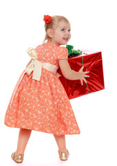 Funny little girl holding a big box