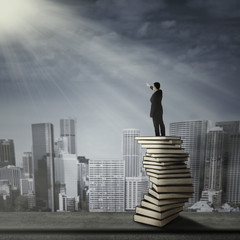 Man standing on a stack of books