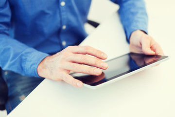 close up of male hands working with tablet pc