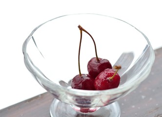 Ice cherry lies in a glass vase