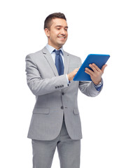 happy businessman in suit holding tablet pc