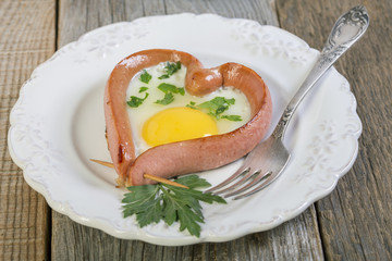 Heart-shaped sausage and scrambled eggs.