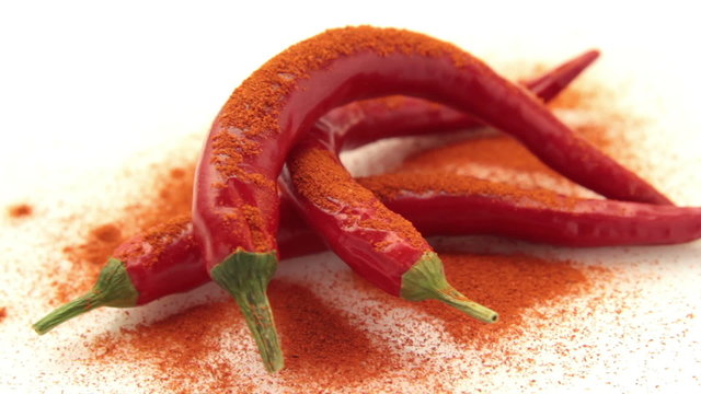 chili pepper with chili powder tracking on white