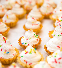 small homemade cakes with white cream for party