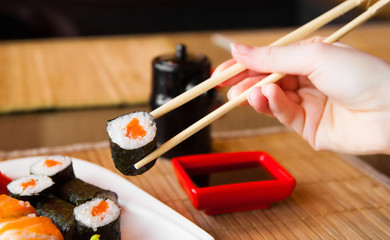 sushi keep chopsticks and dipped into the sauce