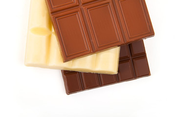 different sorts of chocolate in a stack on white background