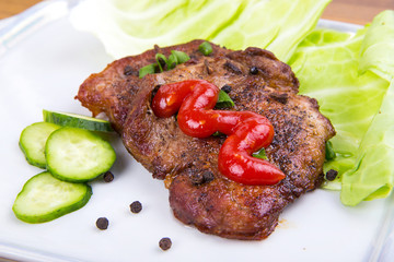 tasty grill meat with sauce and green on white plate