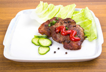 tasty grill meat with sauce and green on white plate