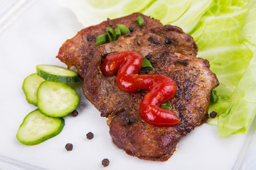 tasty grill meat with sauce and green on white plate