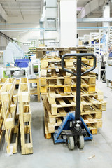 The image of manual loader with wooden pallets