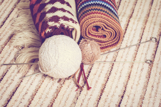 Knitting needles and yarn on rustic