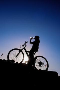 Cyclist drinking water.