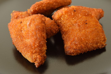 Plate of chicken nuggets with dip sauce.