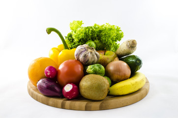 Fresh fruits and vegetables on wooden board
