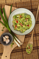 Guacamole with green onions. Selective focus.