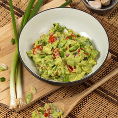Guacamole with green onions. Selective focus.