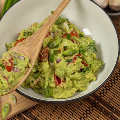 Guacamole with green onions. Selective focus.