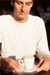 young man having a cappuccino