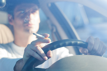 driving while holding a cigarette in hand