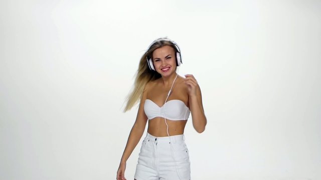 Beautiful female in headphones listening to the music with