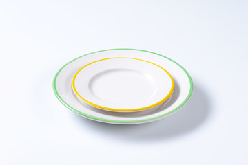 Two rimmed plates