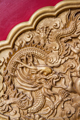 Golden dragon decorated on red wall