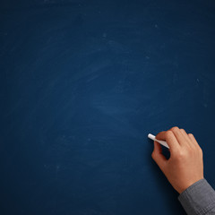 Hand writing on blank blue chalkboard