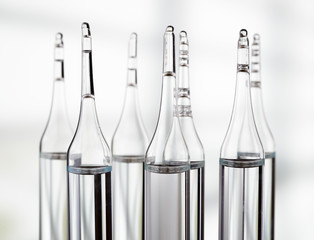 Several ampoules on light background