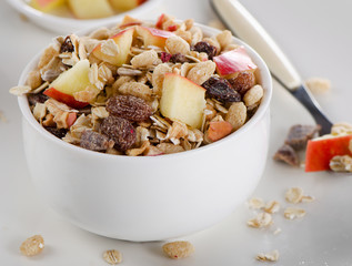Muesli and fruits for breakfast in a white bowl