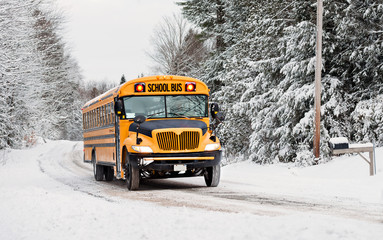 School Bus Driving in Winter on a Snow Covered Road - 78137324