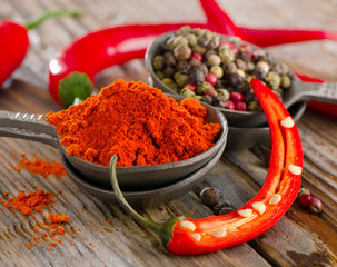 Black  and red  peppers on  wooden table.