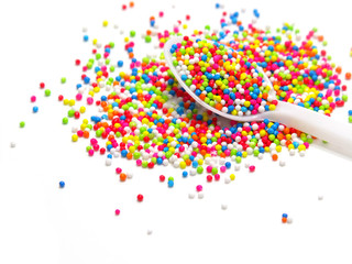 Fototapeta na wymiar colorful sugar pearls in white spoon
