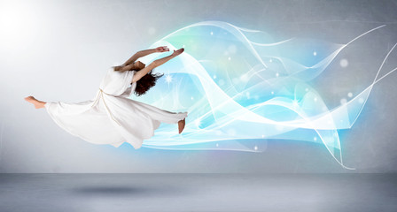 Naklejka premium Cute teenager jumping with abstract blue scarf around her