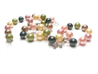 pastel colored bead and pearls on a white background