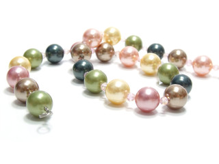 pastel colored bead and pearls on a white background