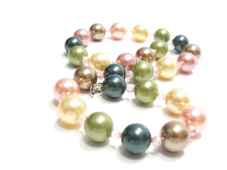 pastel colored bead and pearls on a white background