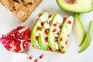 Avocado with Feta, pomegranate on sunflower seeds bread sandwich