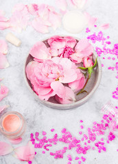 Roses in bowl with water on marble table with sea salt
