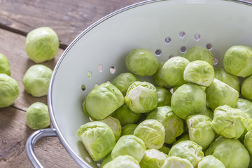 Brussels sprouts in a sieve on a table