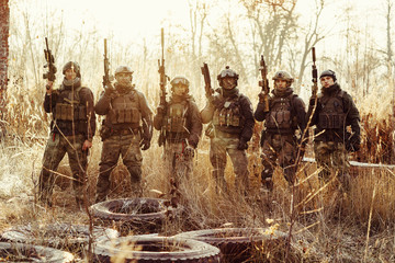 group of soldiers standing with arms and looking at the camera