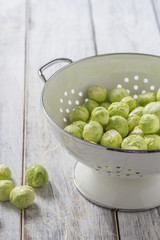 Brussels sprouts in a sieve on a table