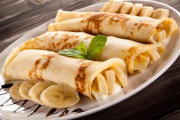 Pancakes with cream and bananas