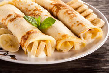 Pancakes with cream and bananas